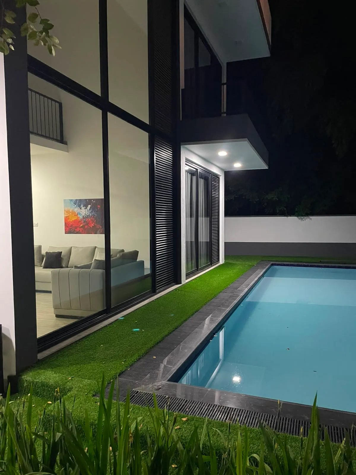 Private walled pool at TenTwo villa near Kandy at night